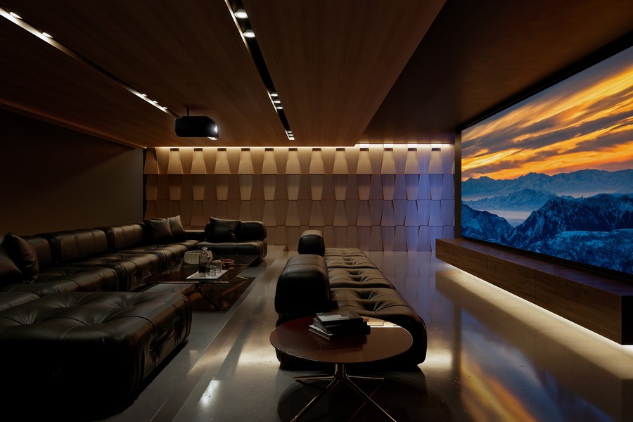 A home theater with leather seating, a projector on the ceiling and large projector screen. 